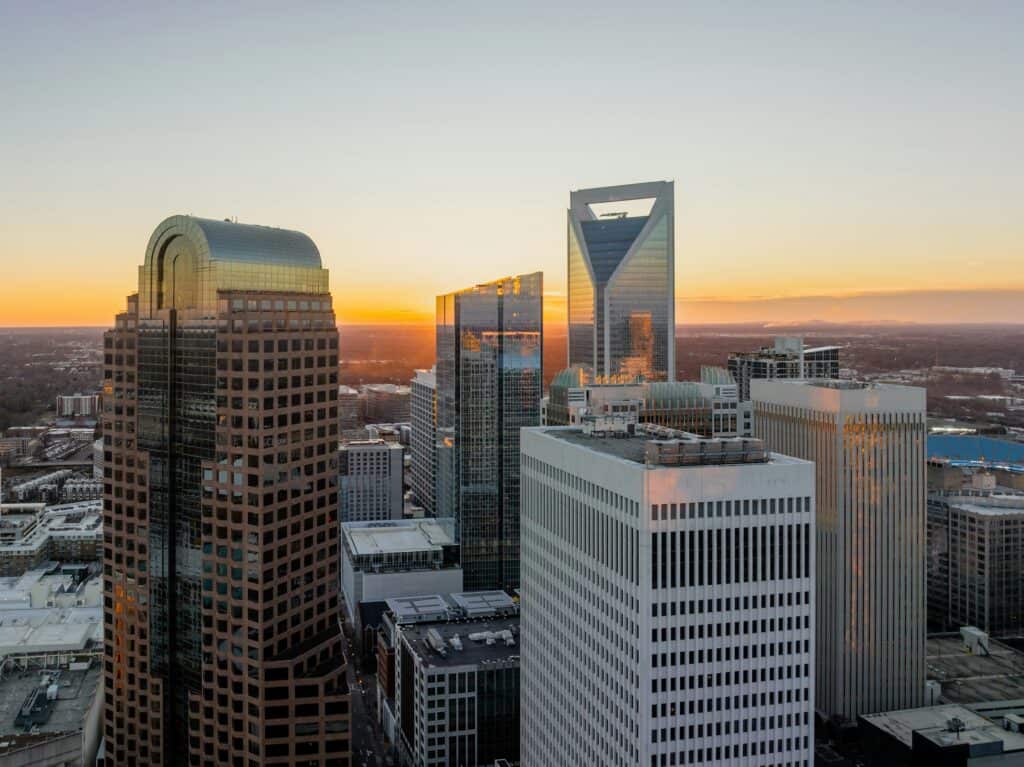 Aerial sunrise view of the Charlotte skyline, emphasizing Warehouse Recruiters' commitment to strengthening warehouse and distribution center leadership in the region,