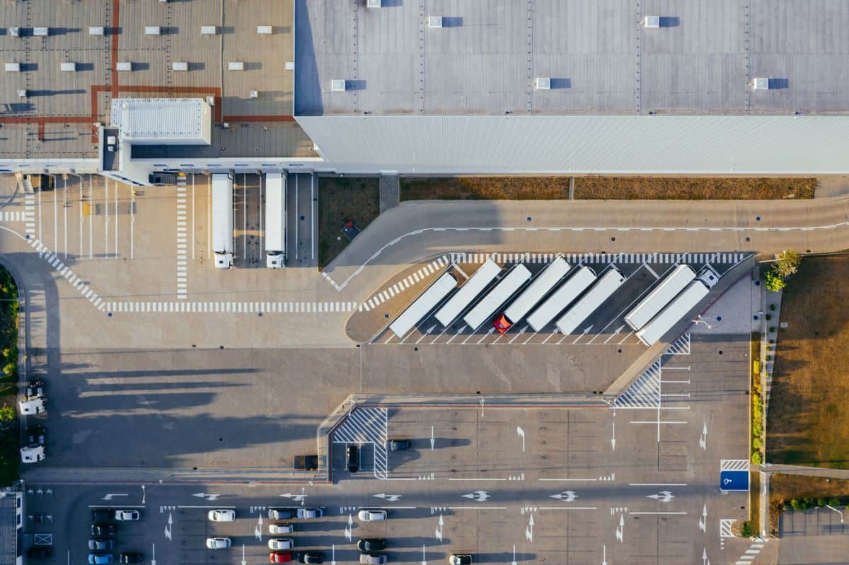 Peak season warehouse hiring supports a busy logistics center with trucks during the Q4 surge
